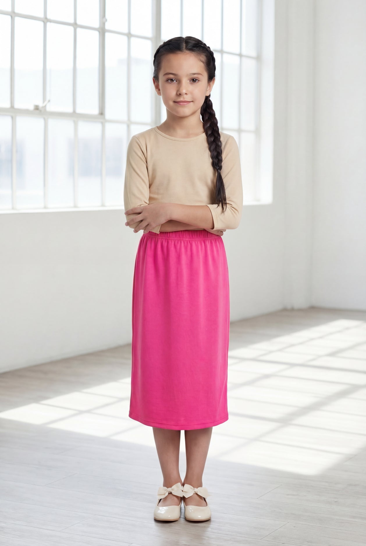 Model wearing Nuggles® Girls Classic Skirt in Pink