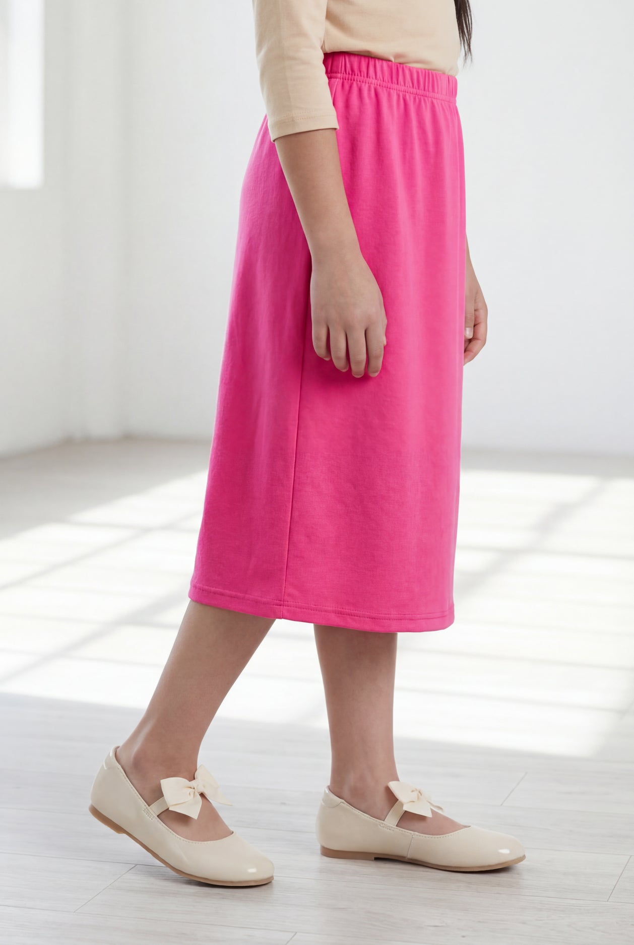 Model wearing Nuggles® Girls Classic Skirt in Pink