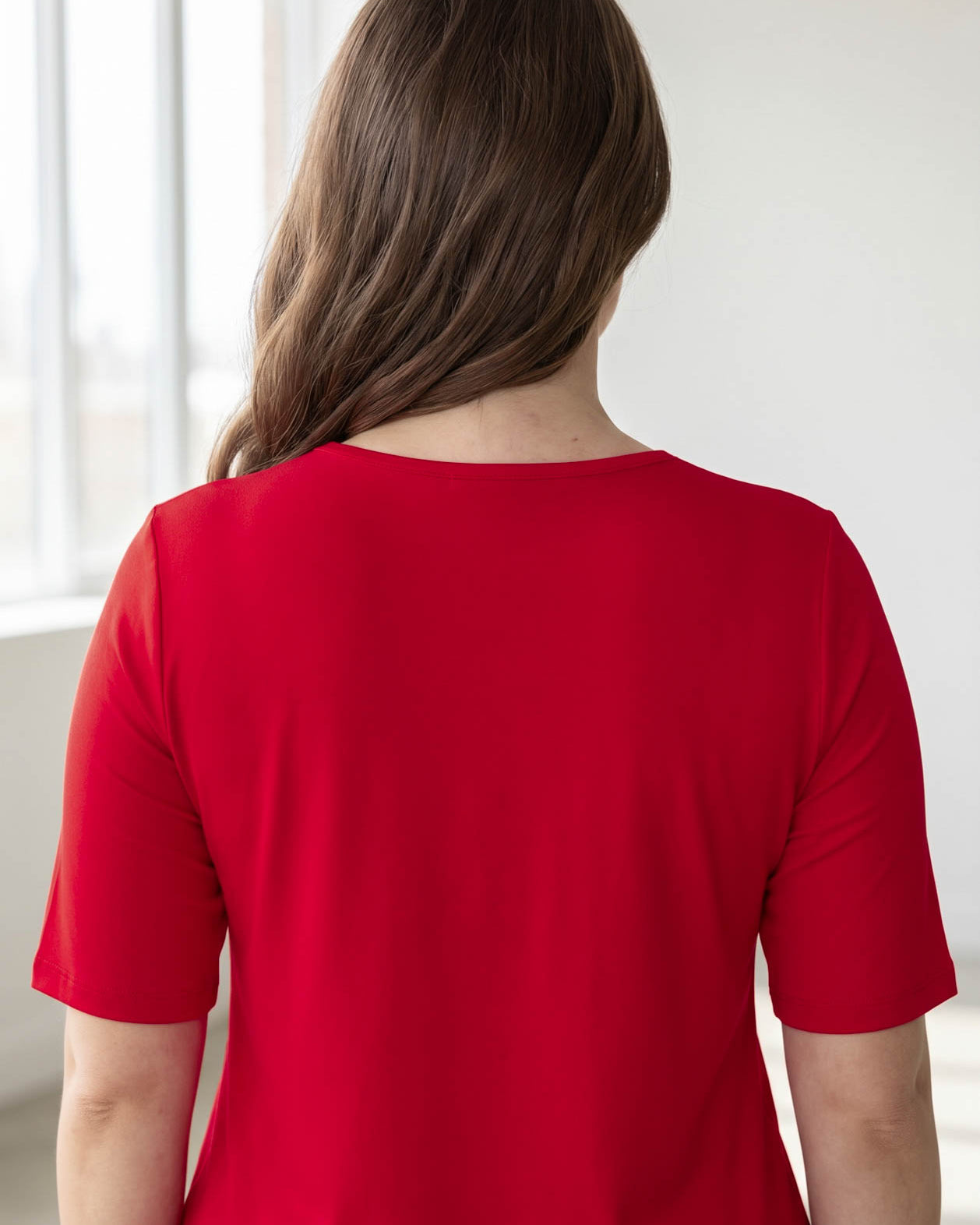 Model wearing the Nuggles® Essential Half Sleeve Tee in Red
