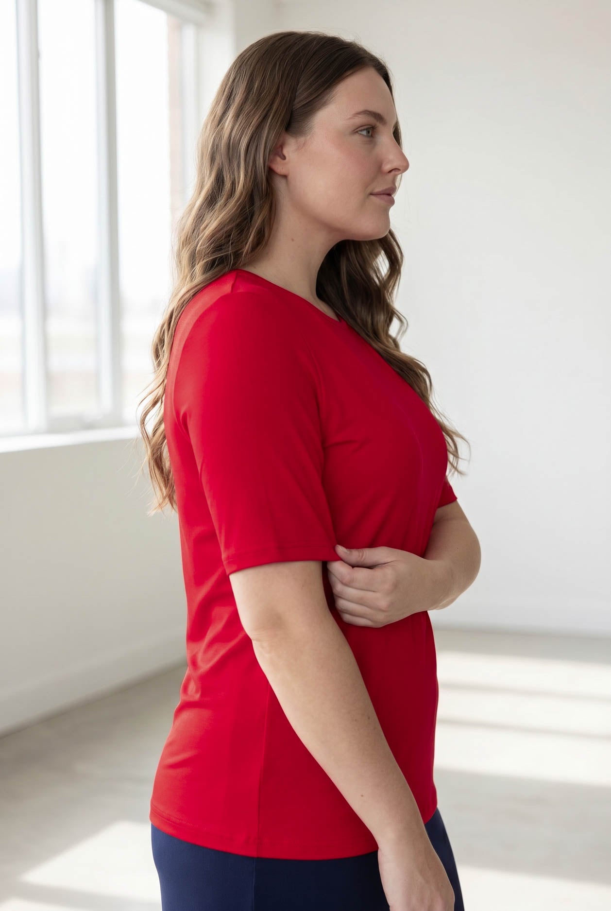 Model wearing the Nuggles® Essential Half Sleeve Tee in Red