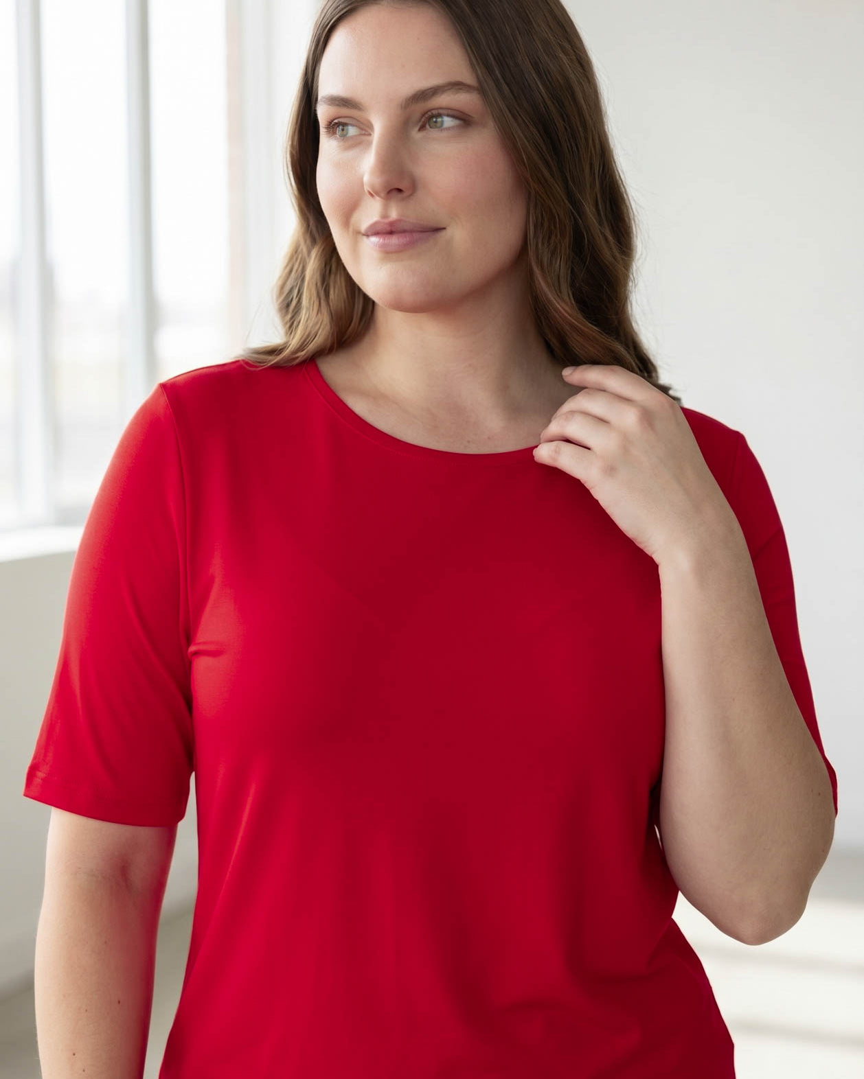 Model wearing the Nuggles® Essential Half Sleeve Tee in Red