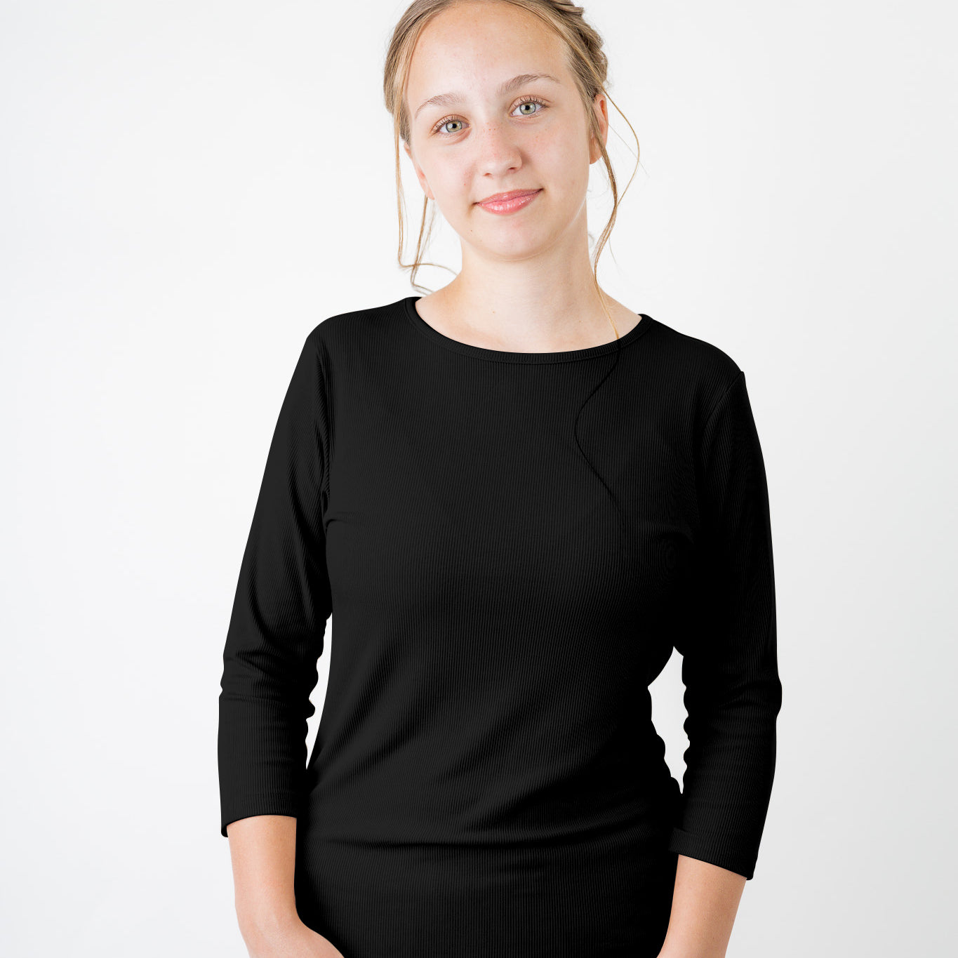 Model wearing the  Nuggles®  Essential 3/4 Tee in ribbed fabric, a modest, fitted top with 3/4 sleeves and a rounded neckline. Shown in a neutral tone, ideal for layering.