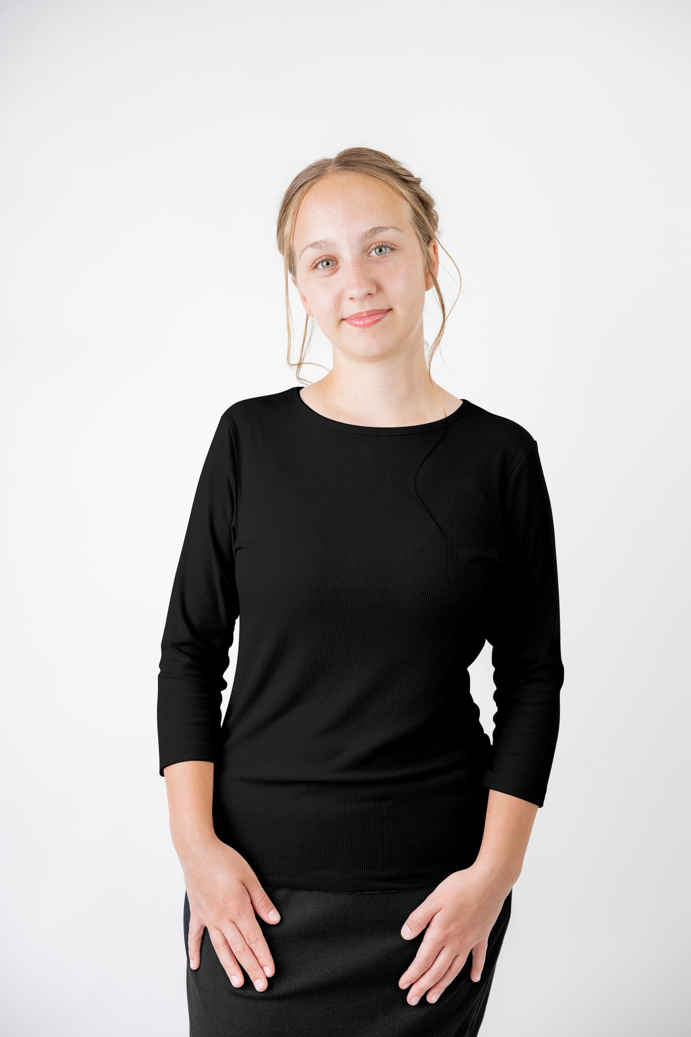 Model wearing the  Nuggles®  Essential 3/4 Tee in ribbed fabric, a modest, fitted top with 3/4 sleeves and a rounded neckline. Shown in a neutral tone, ideal for layering.