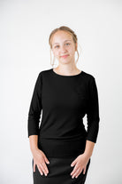 Model wearing the  Nuggles®  Essential 3/4 Tee in ribbed fabric, a modest, fitted top with 3/4 sleeves and a rounded neckline. Shown in a neutral tone, ideal for layering.