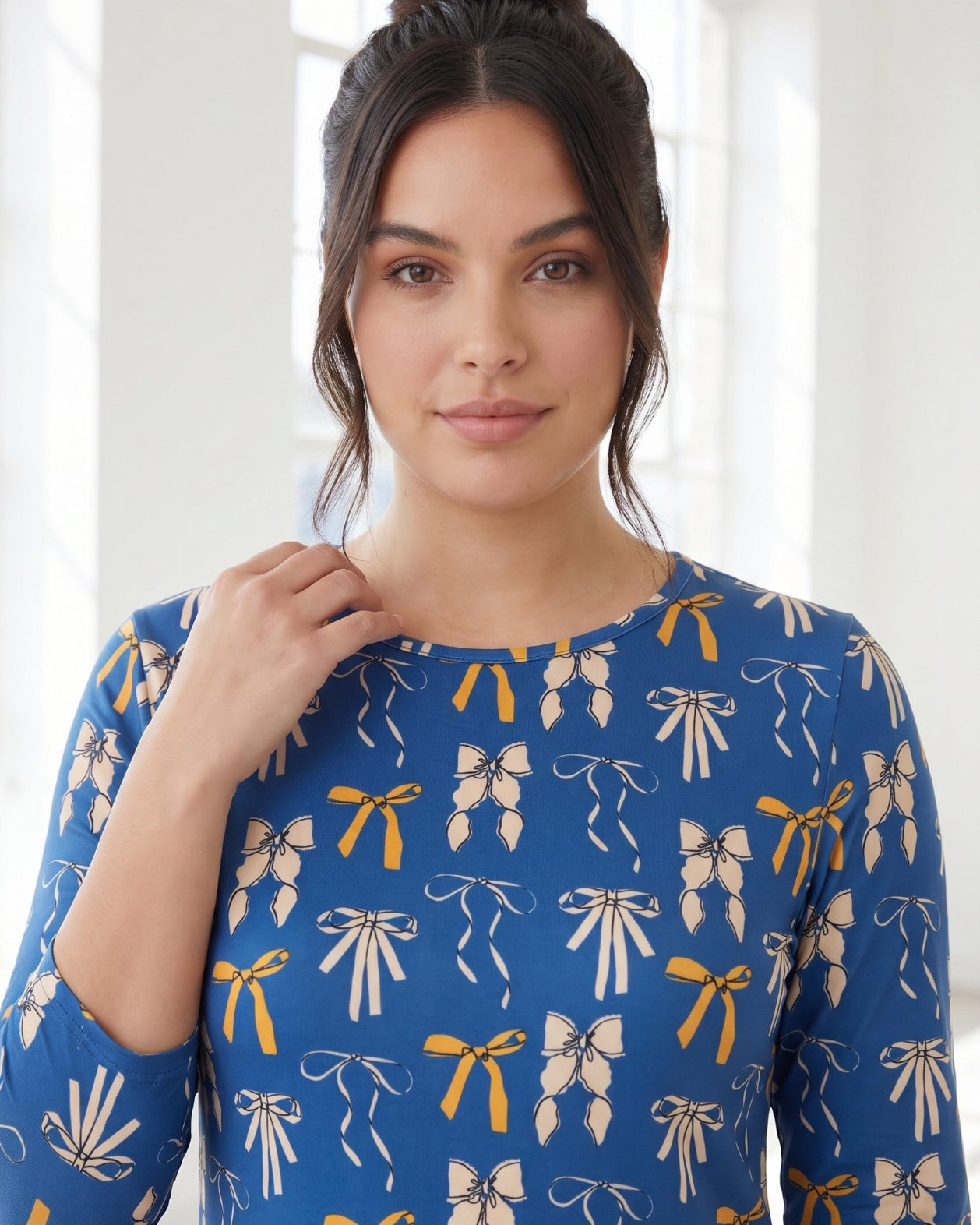 Model wearing Nuggles® 3/4 Essential Tee in Ribbon Day