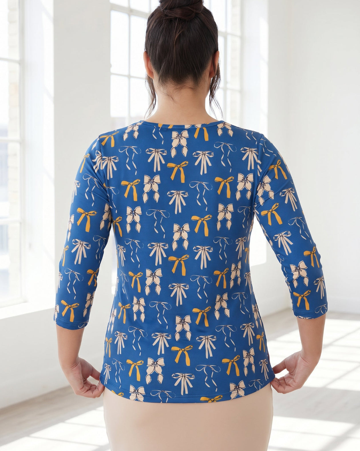 Model wearing Nuggles® 3/4 Essential Tee in Ribbon Day