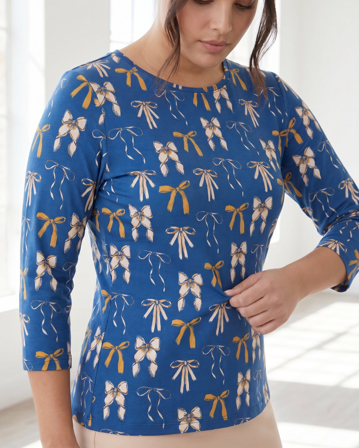 Model wearing Nuggles® 3/4 Essential Tee in Ribbon Day
