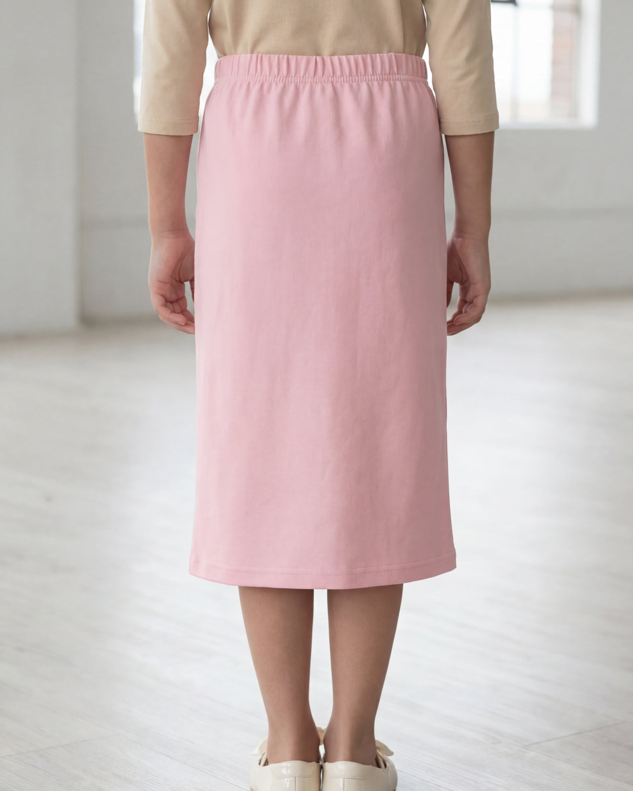 Model wearing the Nuggles® Girls' Classic Midi Skirt in Rose