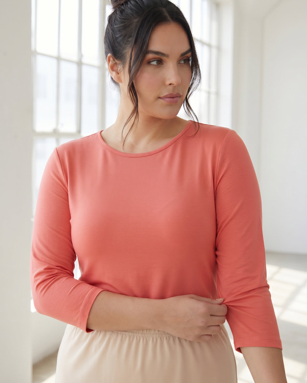 Model wearing Nuggles® 3/4 Essential Tee in Salmon