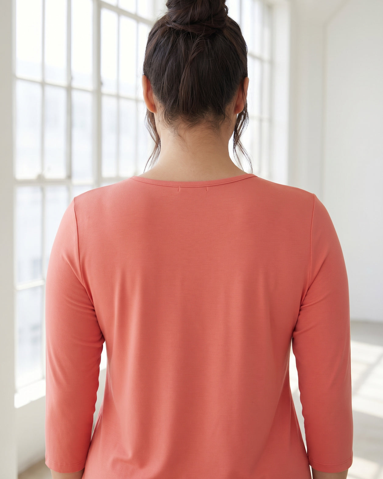 Model wearing Nuggles® 3/4 Essential Tee in Salmon
