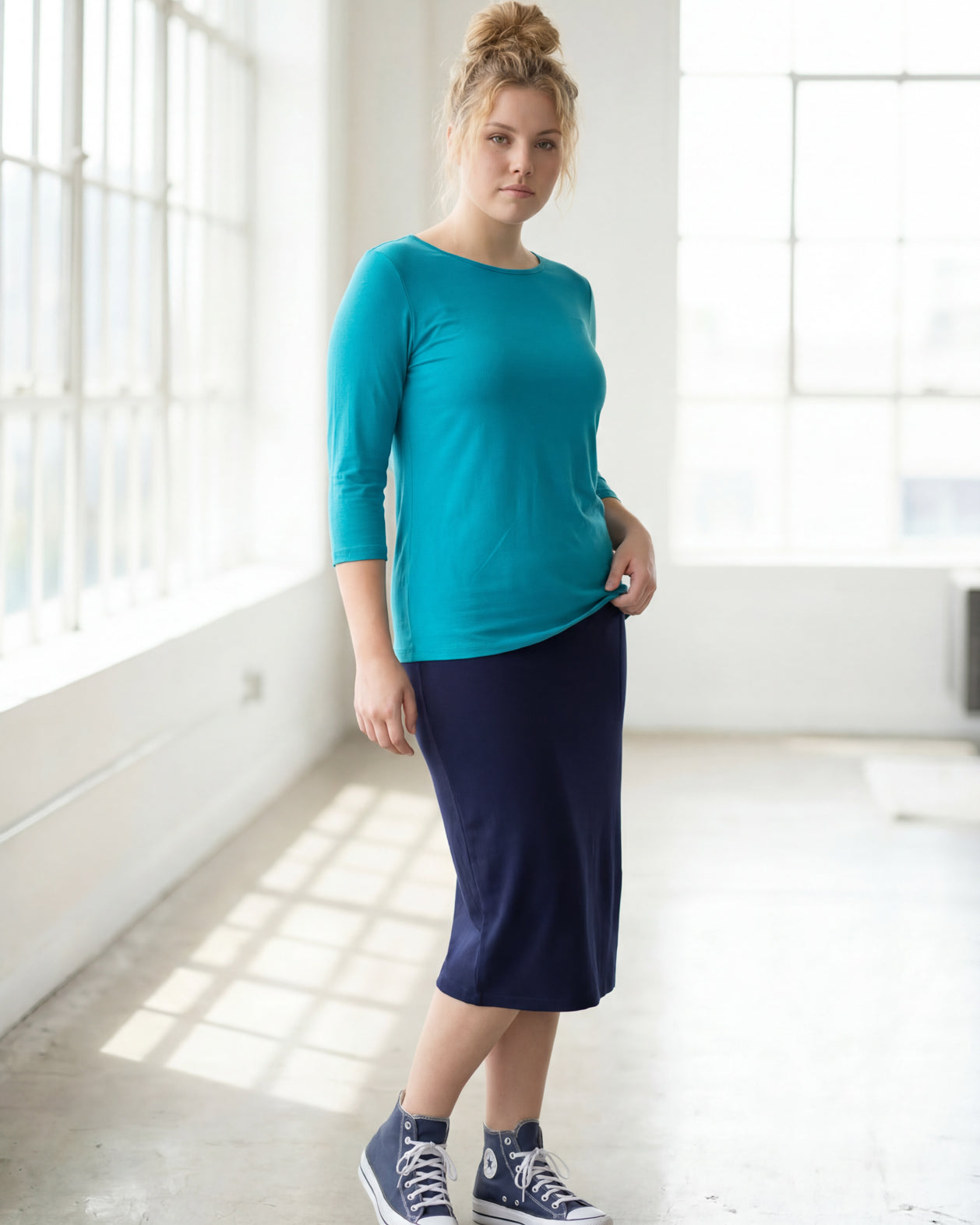 Model wearing the Nuggles® Essential 3/4 Tee in Teal