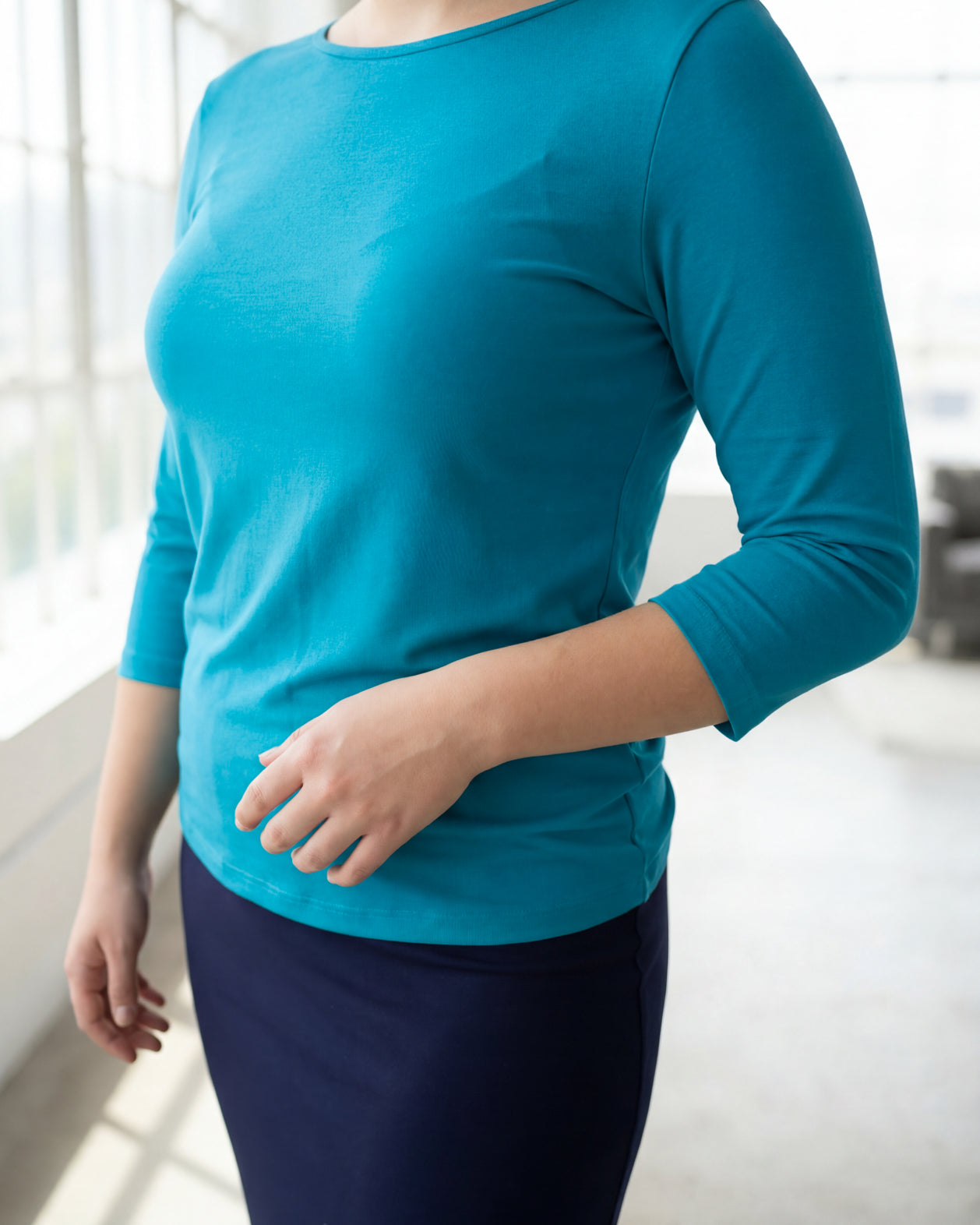 Model wearing the Nuggles® Essential 3/4 Tee in Teal