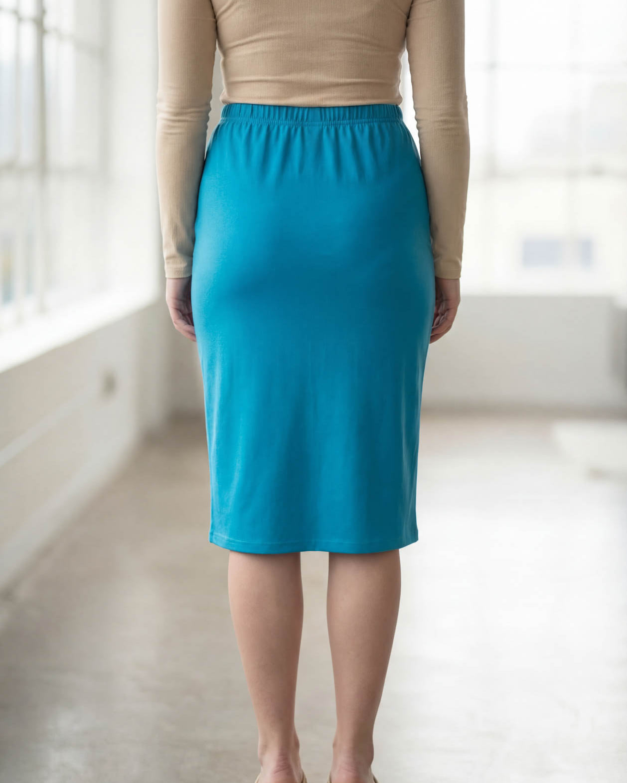 Model wearing Nuggles® 27" Classic Skirt in Turquoise