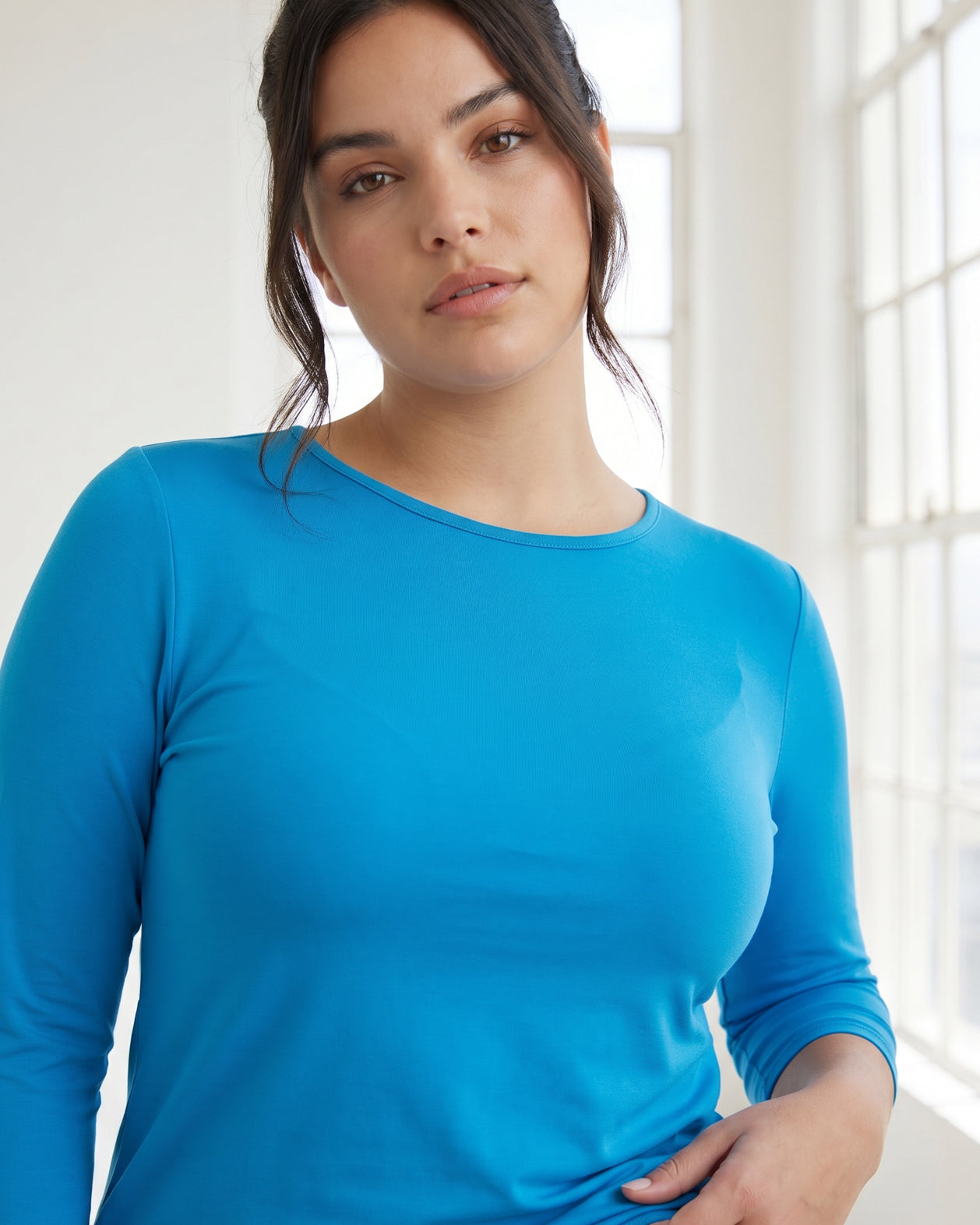 Model wearing Nuggles® 3/4 Essential Tee in Turquoise