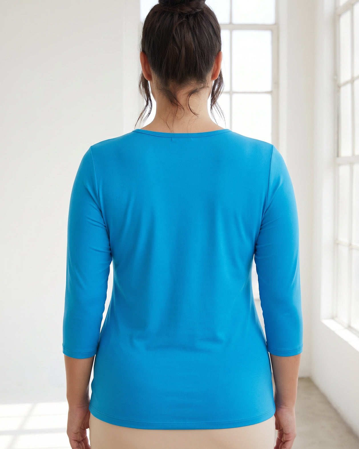 Model wearing Nuggles® 3/4 Essential Tee in Turquoise