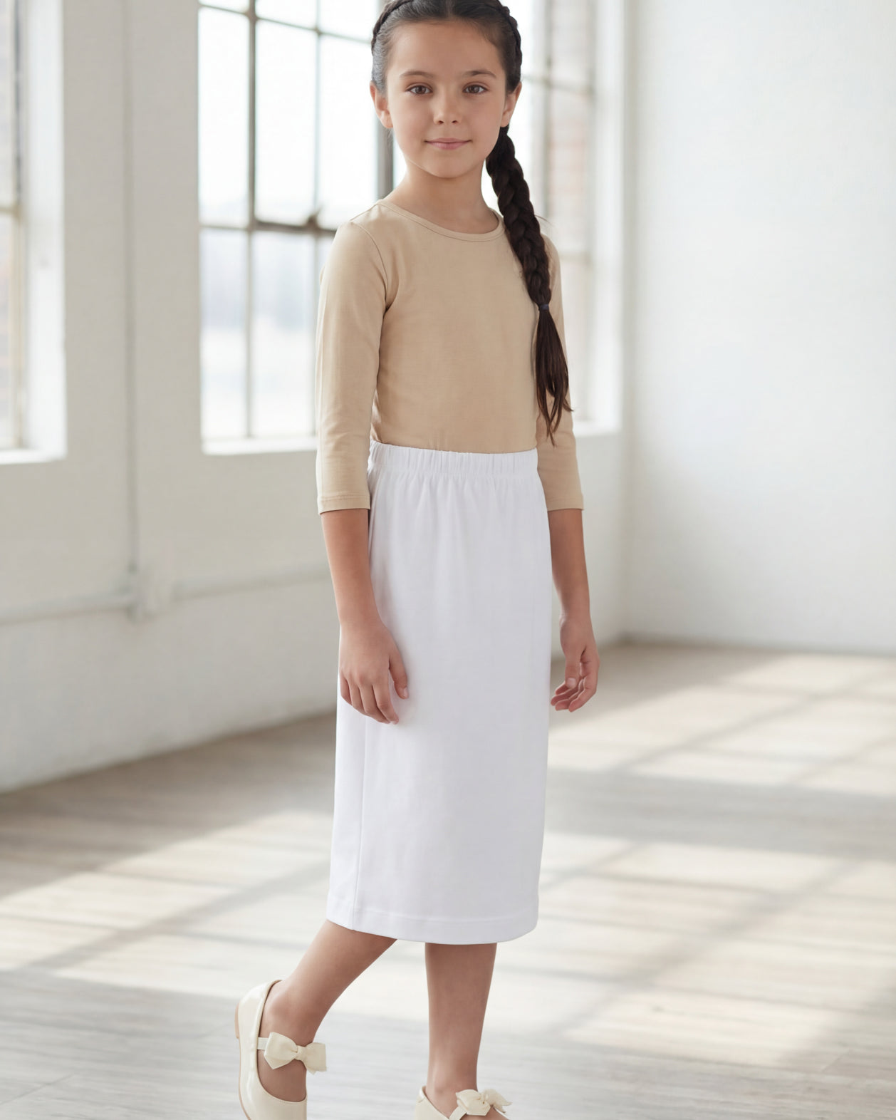 Model wearing Nuggles® Girls Classic Skirt in White