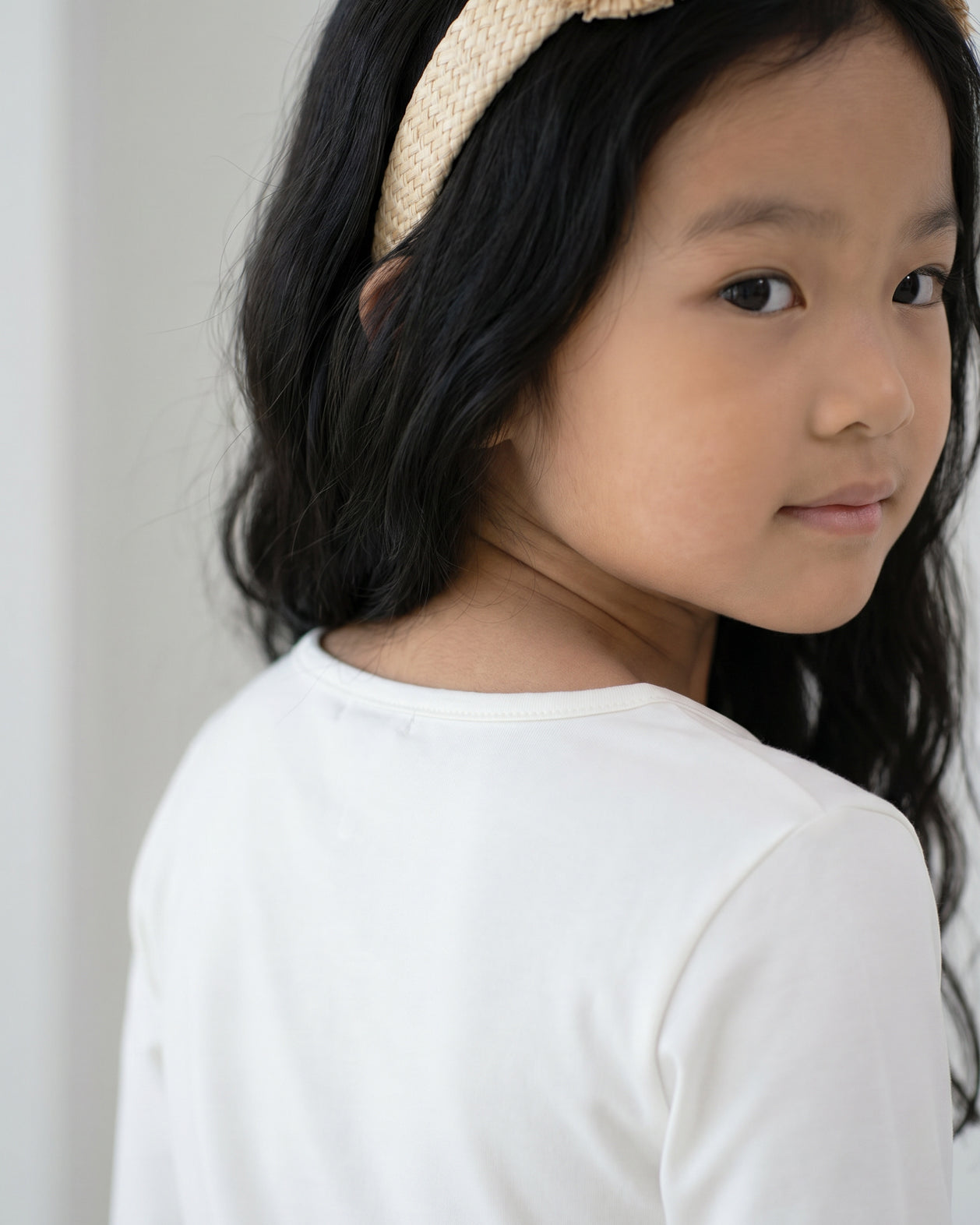 Model wearing the Girls' Nuggles® Essential 3/4 Tee in White
