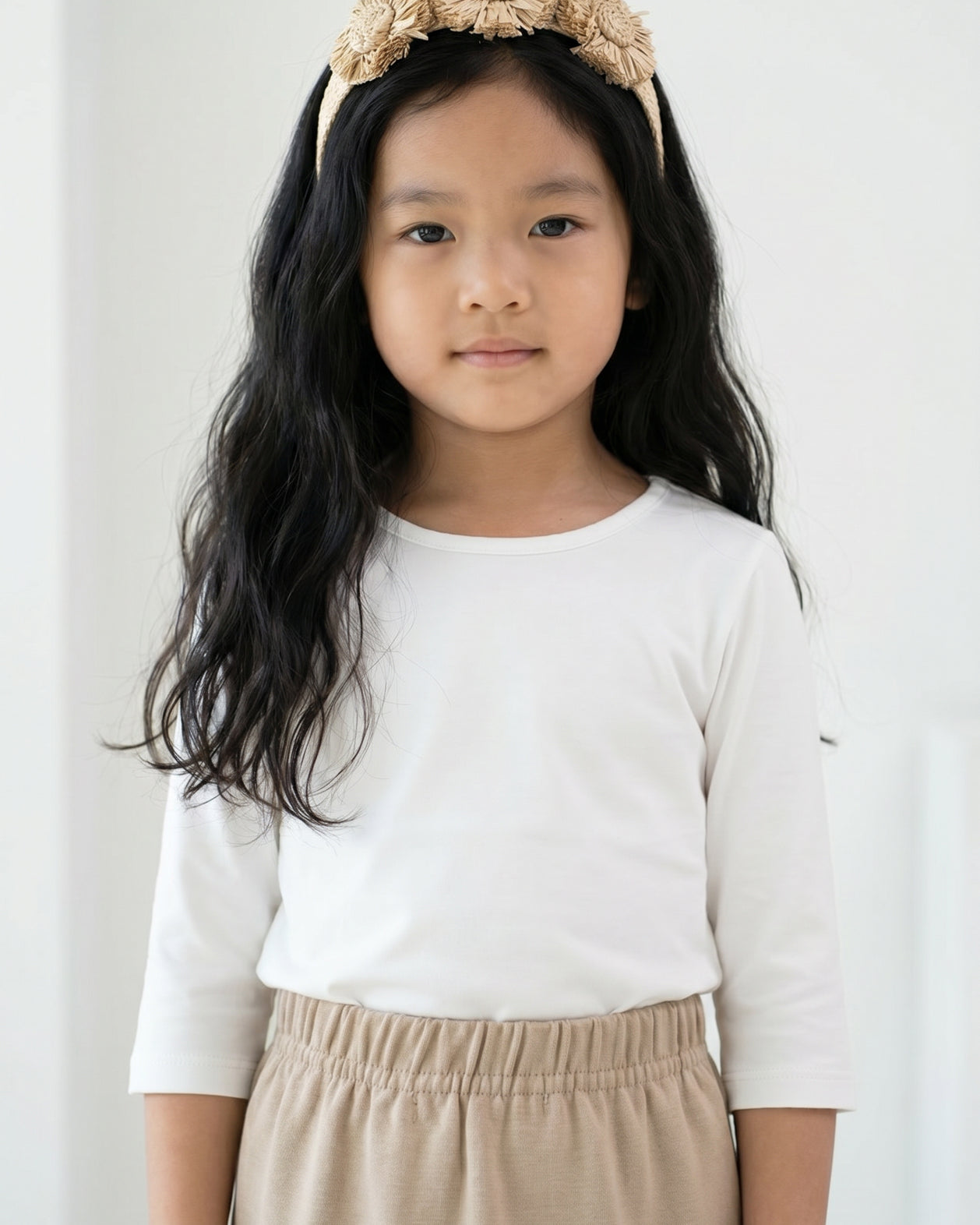 Model wearing the Girls' Nuggles® Essential 3/4 Tee in White