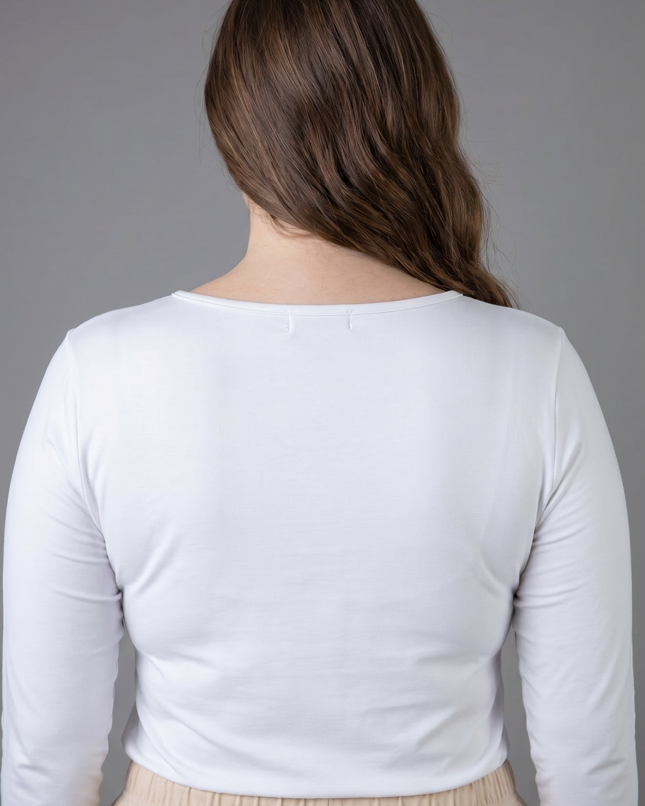 Model wearing Nuggles® Long Sleeve Essential Tee in White