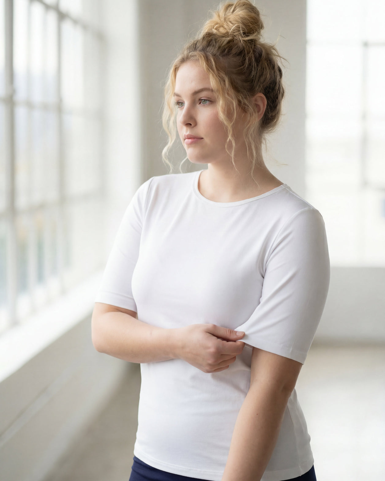 Model wearing the Nuggles® Essential Half Sleeve Tee in White