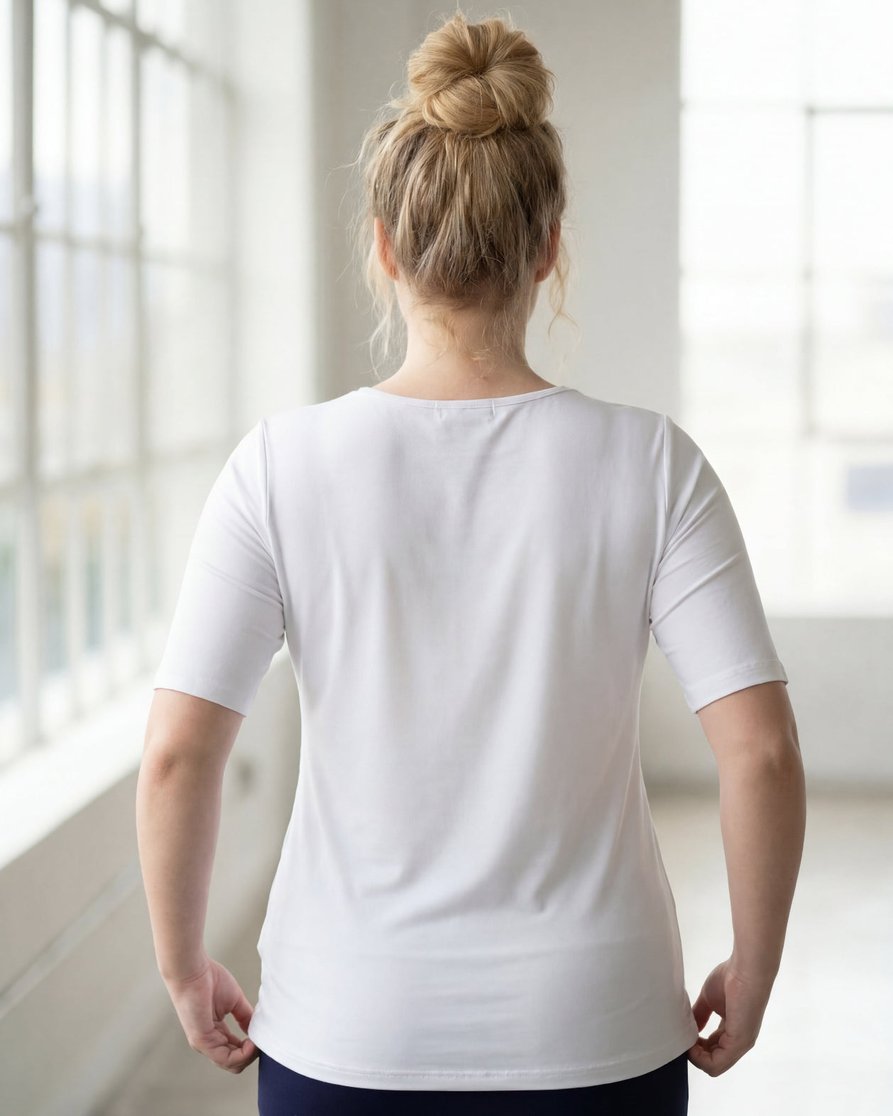 Model wearing the Nuggles® Essential Half Sleeve Tee in White