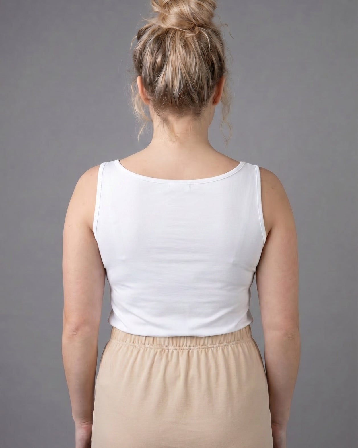 Model wearing Nuggles® Wide Neck Tank in White