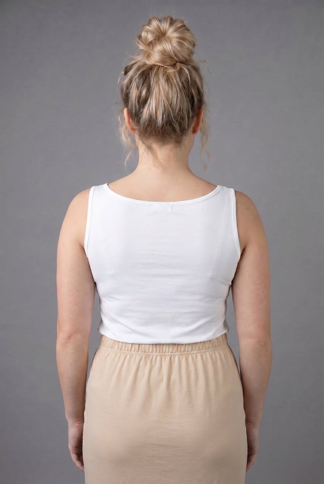Model wearing Nuggles® Wide Neck Tank in White
