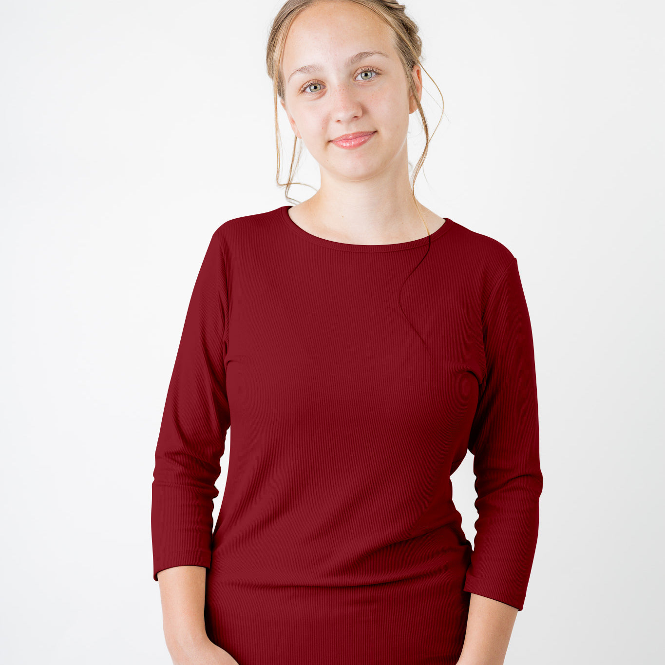 Model wearing the  Nuggles®  Essential 3/4 Tee in ribbed fabric, a modest, fitted top with 3/4 sleeves and a rounded neckline. Shown in a neutral tone, ideal for layering.