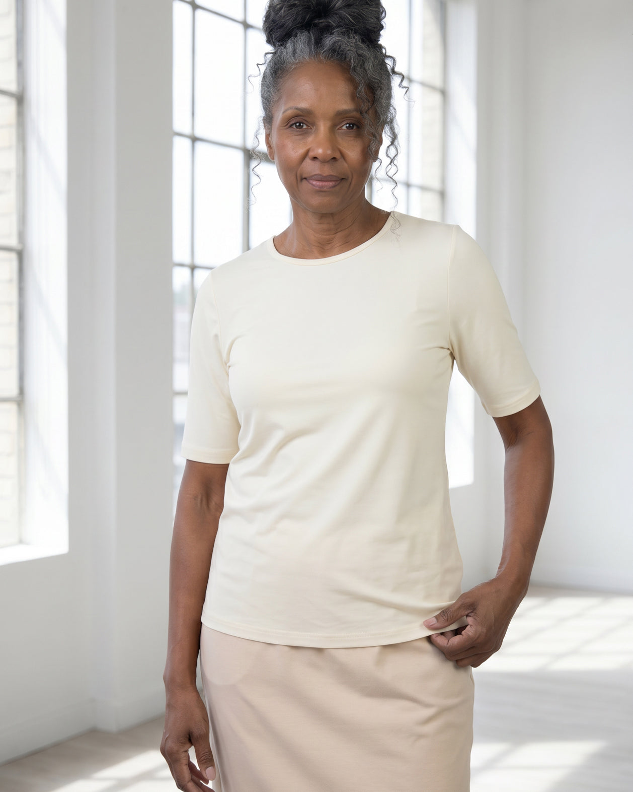 Model wearing Nuggles® Half Sleeve Essential Tee in Cream