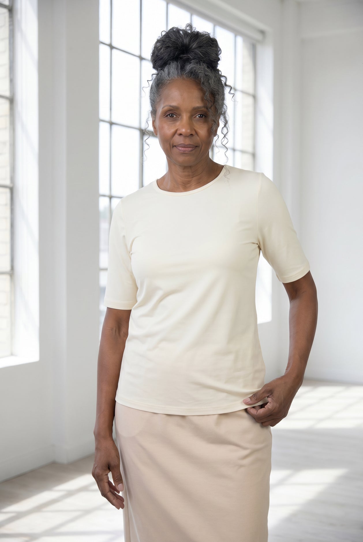 Model wearing Nuggles® Half Sleeve Essential Tee in Cream
