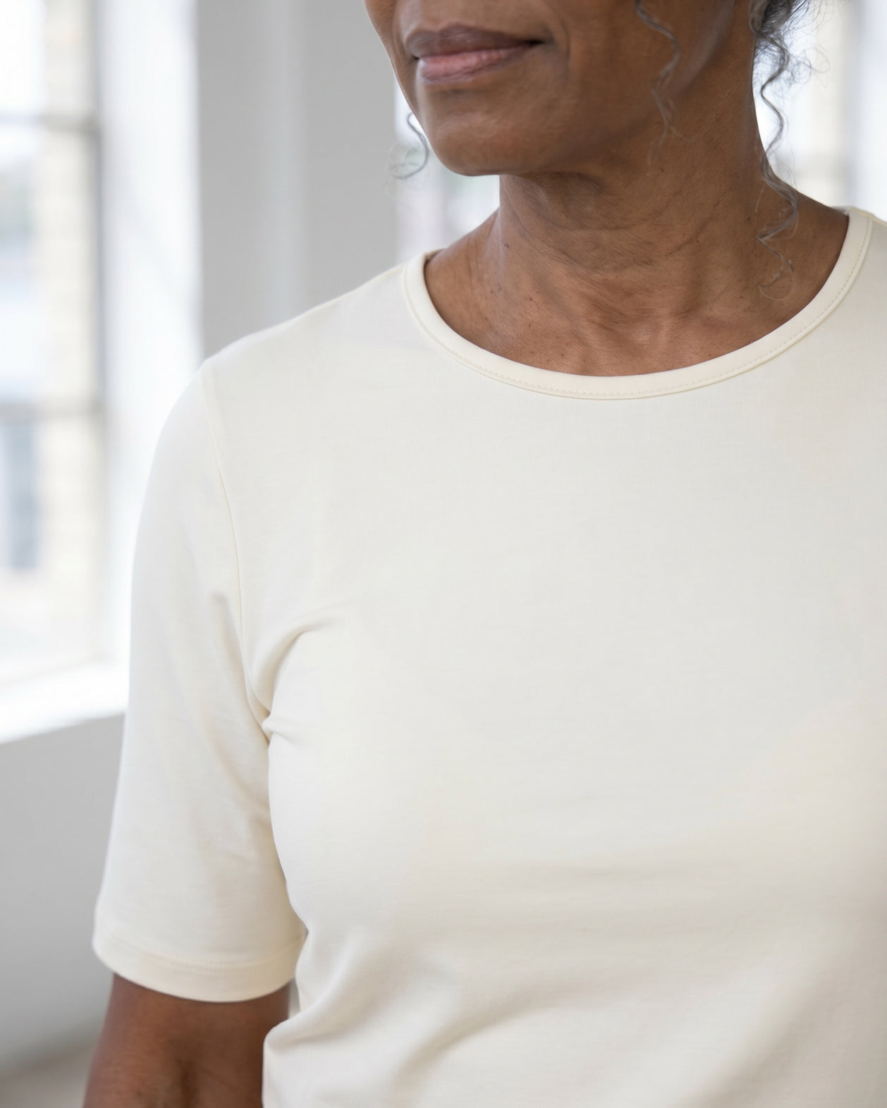 Model wearing Nuggles® Half Sleeve Essential Tee in Cream