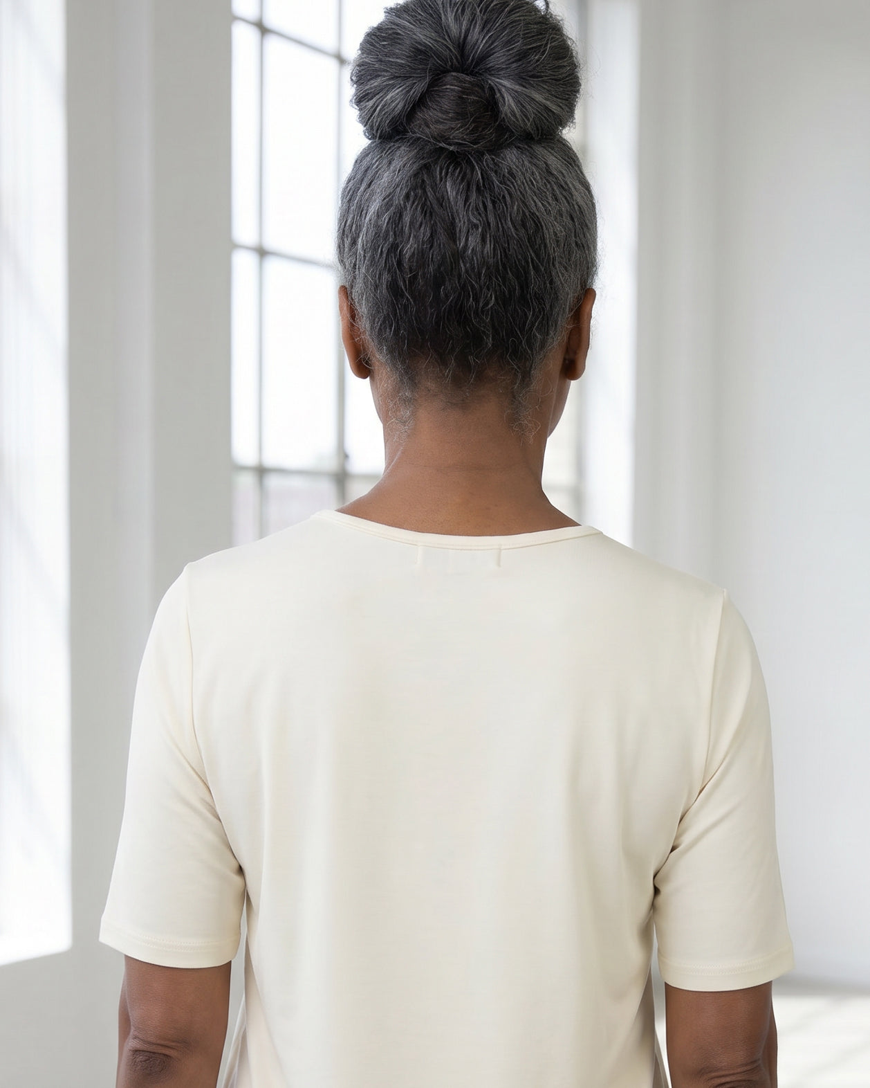Model wearing Nuggles® Half Sleeve Essential Tee in Cream