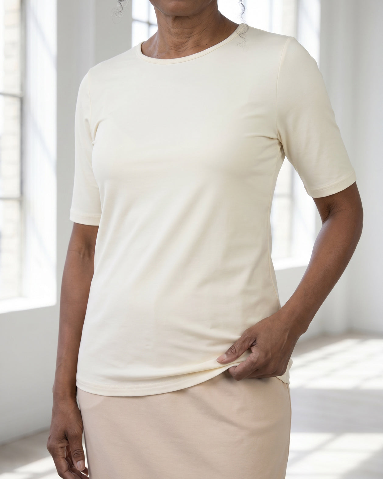 Model wearing Nuggles® Half Sleeve Essential Tee in Cream