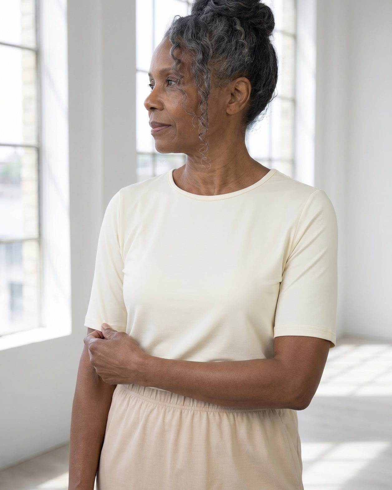 Model wearing Nuggles® Half Sleeve Essential Tee in Cream