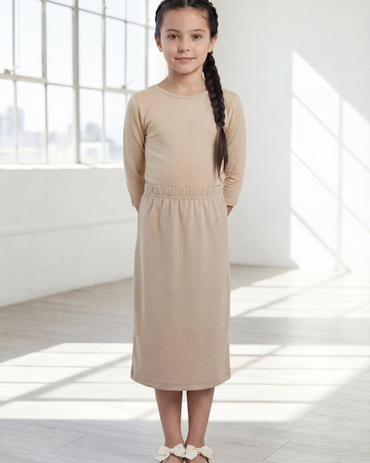 Model wearing the Nuggles® Girls' Classic Midi Skirt in Khaki