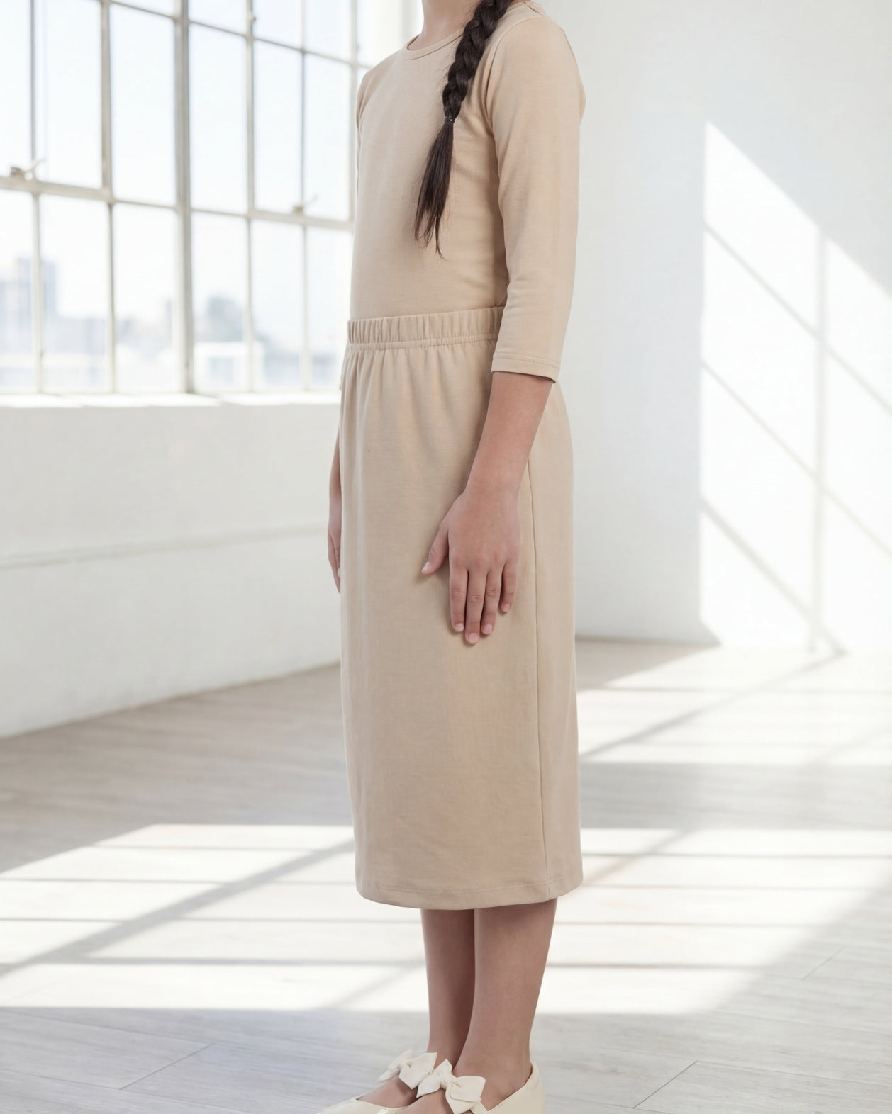 Model wearing the Nuggles® Girls' Classic Midi Skirt in Khaki