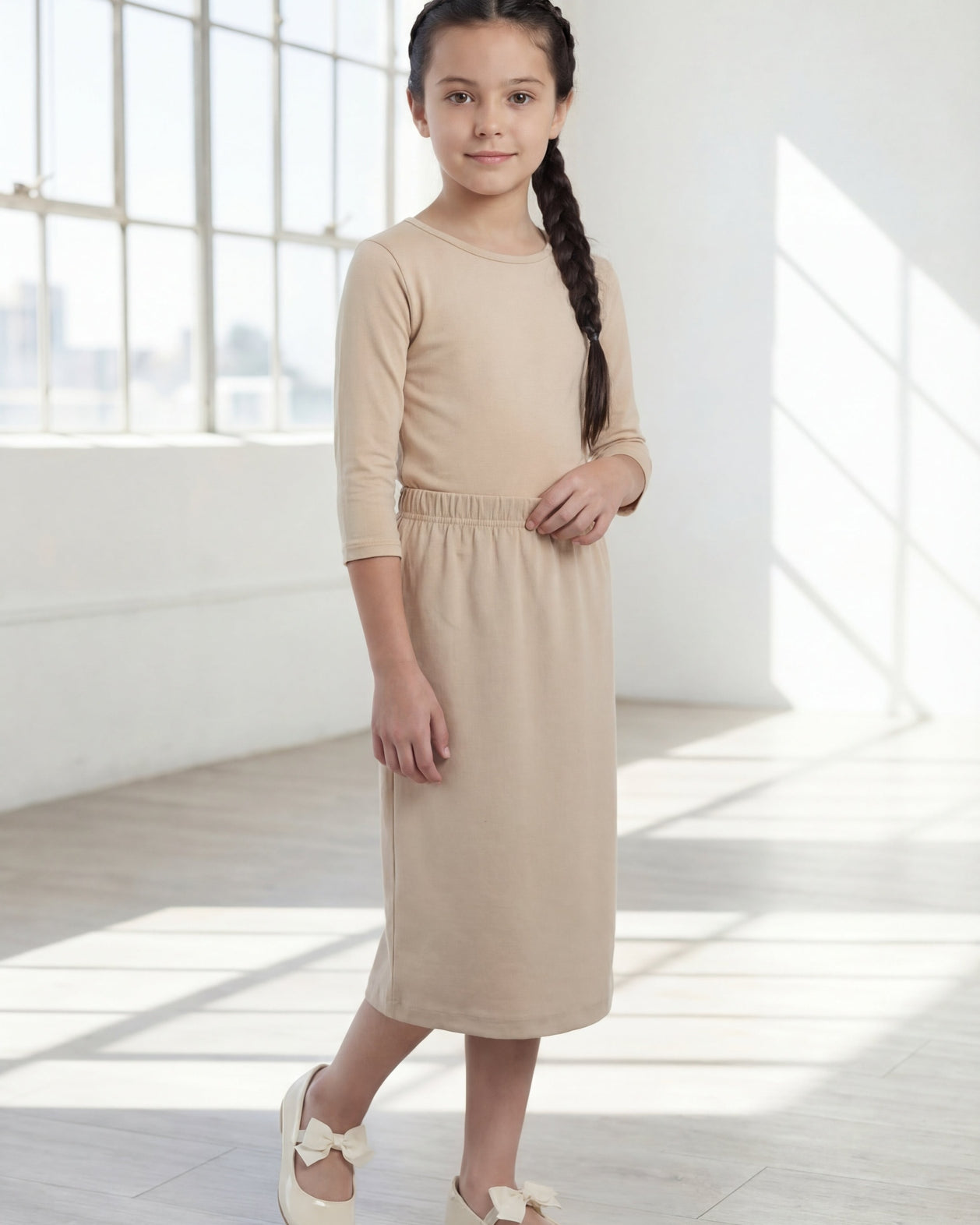 Model wearing the Nuggles® Girls' Classic Midi Skirt in Khaki