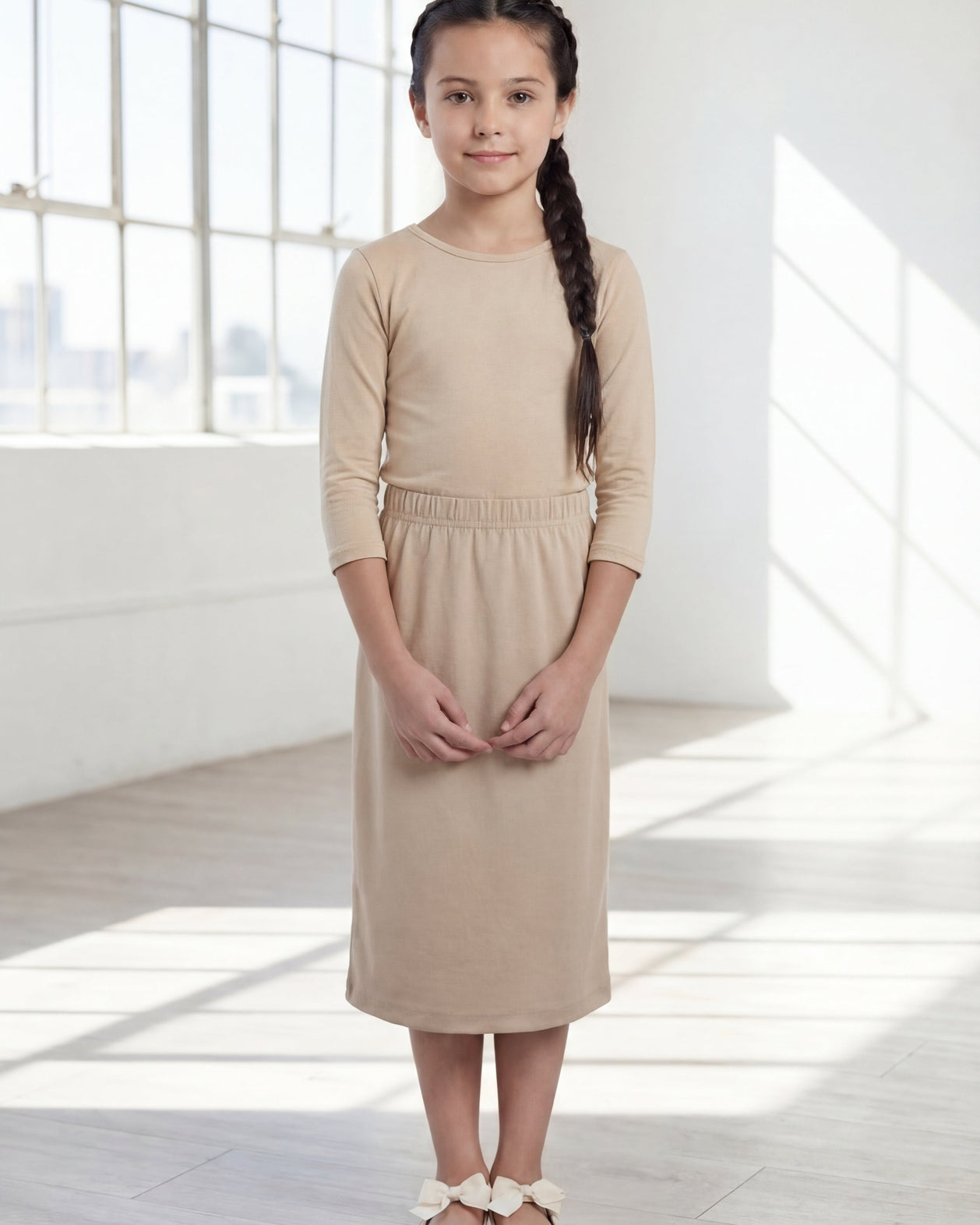 Model wearing the Nuggles® Girls' Classic Midi Skirt in Khaki