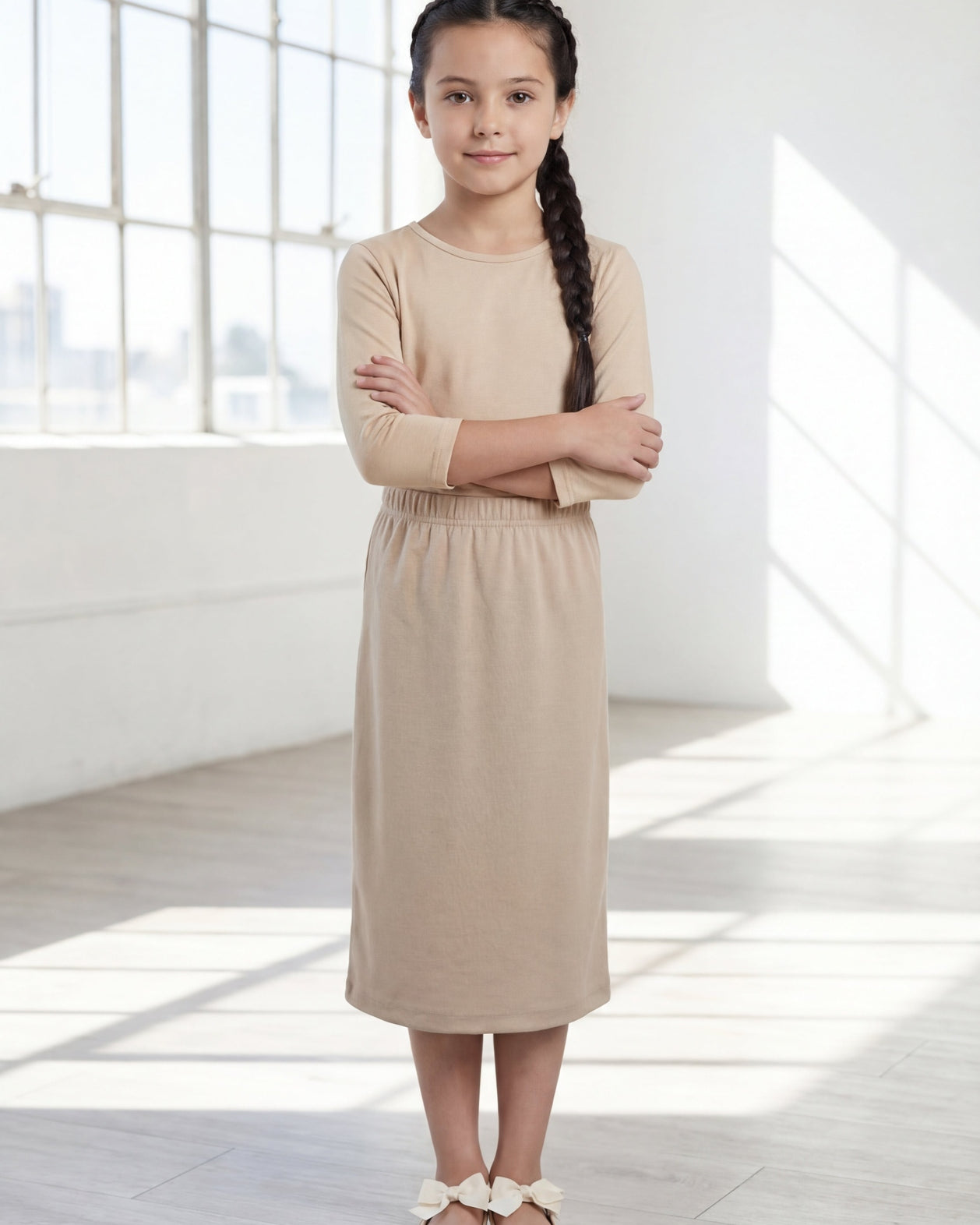Model wearing the Nuggles® Girls' Classic Midi Skirt in Khaki