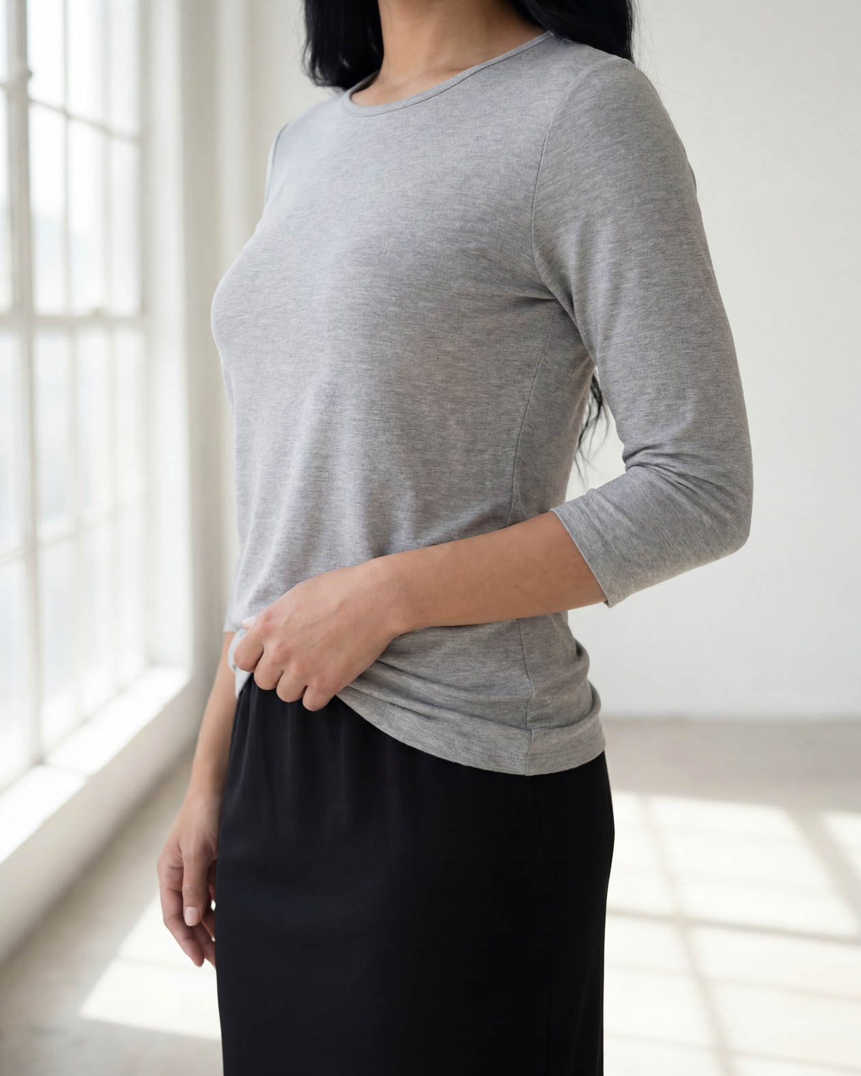 Model wearing Nuggles® 3/4 Essential Tee in Light Heather Gray