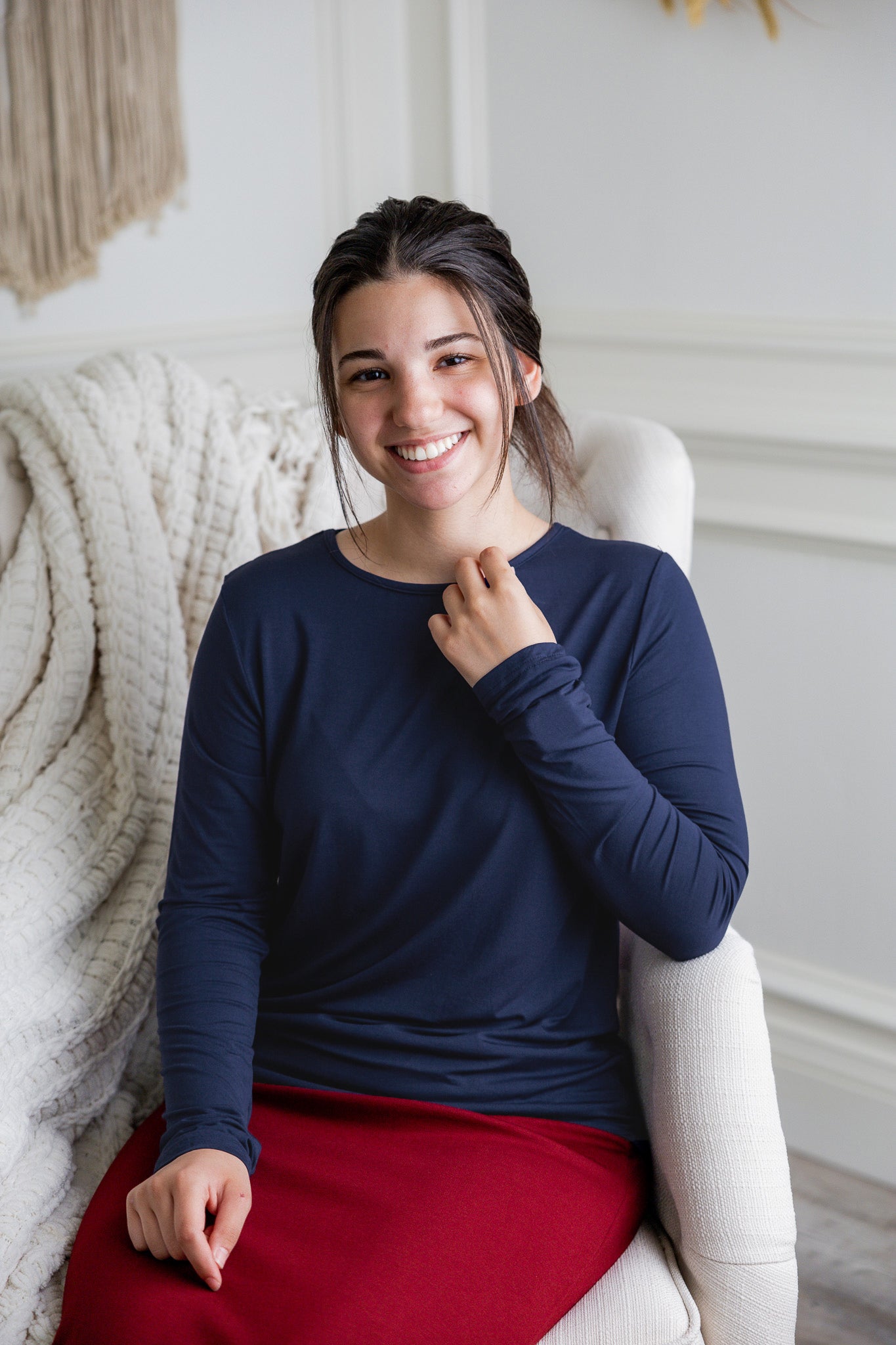 Model styling a neutral Nuggles® long sleeve top for casual everyday outfit inspiration.