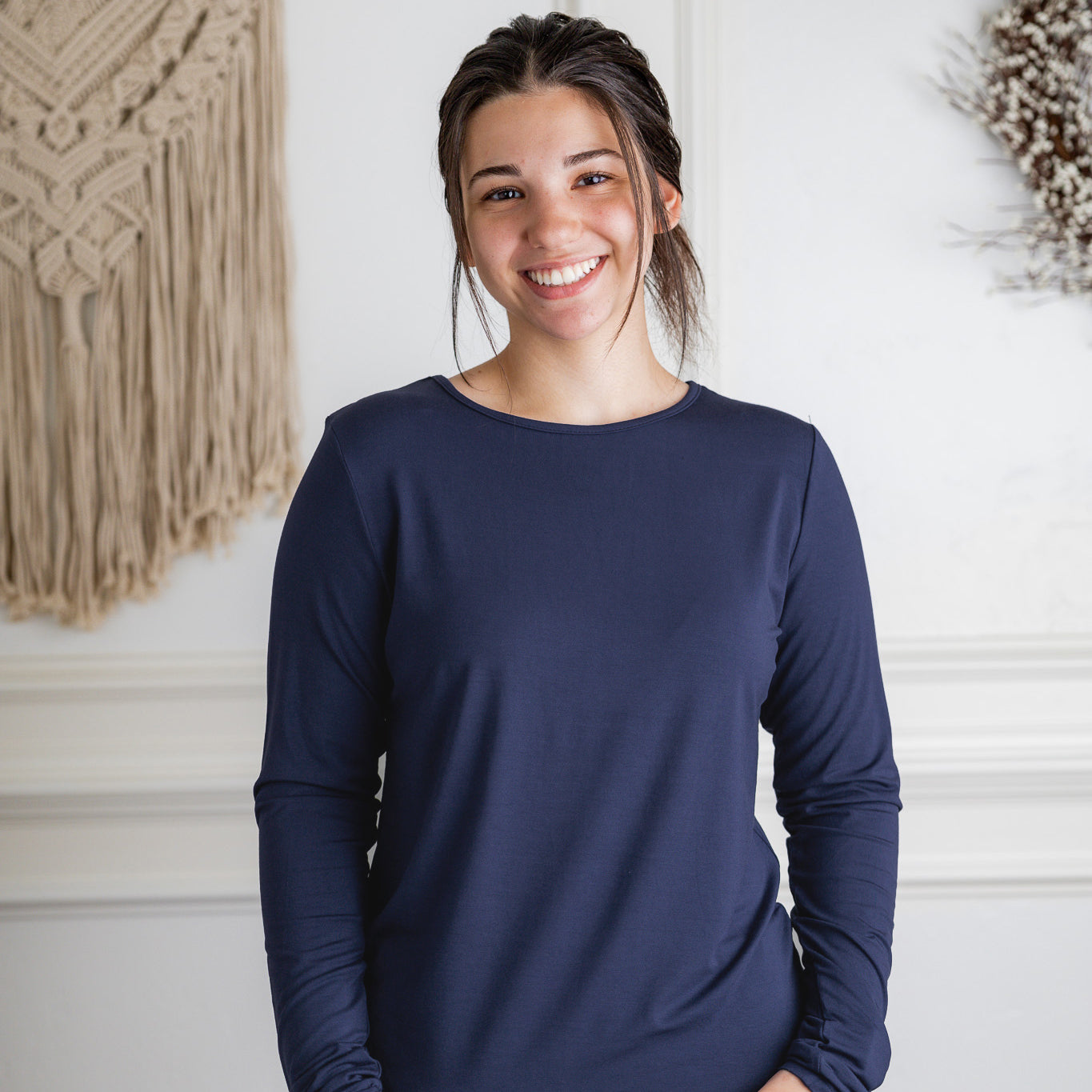 Model styling a neutral Nuggles® long sleeve top for casual everyday outfit inspiration.