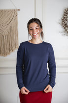 Model styling a neutral Nuggles® long sleeve top for casual everyday outfit inspiration.