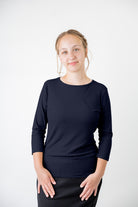 Model wearing the  Nuggles®  Essential 3/4 Tee in ribbed fabric, a modest, fitted top with 3/4 sleeves and a rounded neckline. Shown in a neutral tone, ideal for layering.