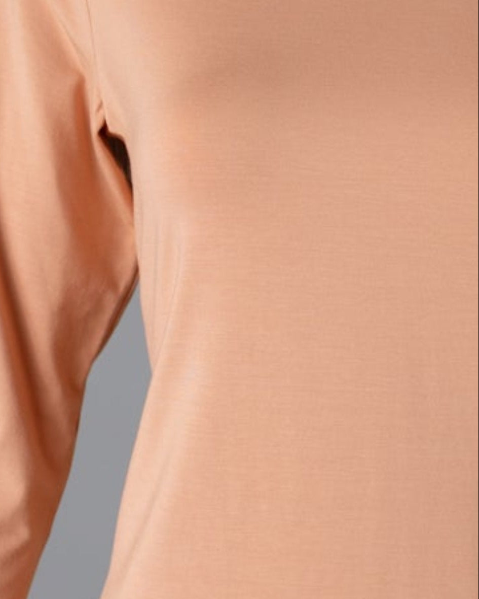Model wearing Nuggles® 3/4 Essential Tee in Peach