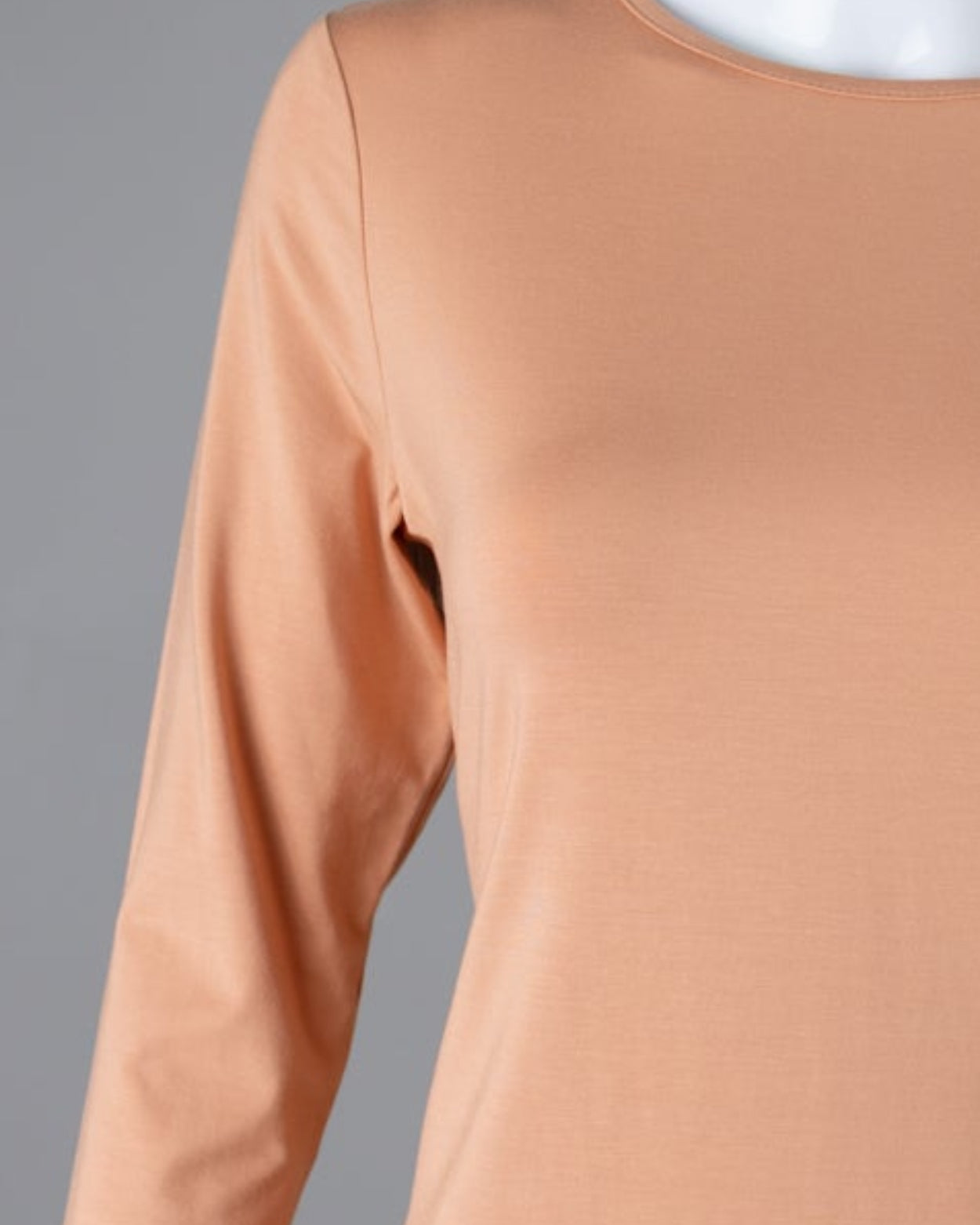 Model wearing Nuggles® 3/4 Essential Tee in Peach