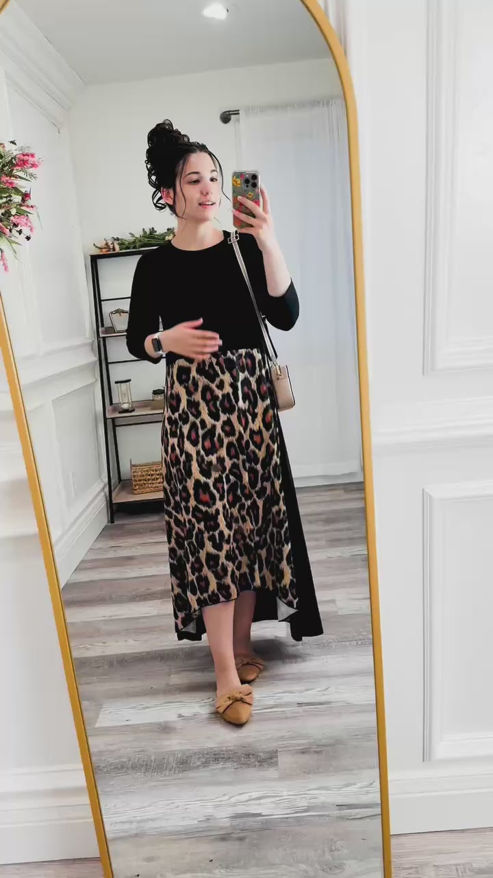 Model wearing the Nuggles Charay Dress, walking and turning to show full front, side, and back views. High-low modest dress with ¾ sleeves, flowy fit, and stylish print options.