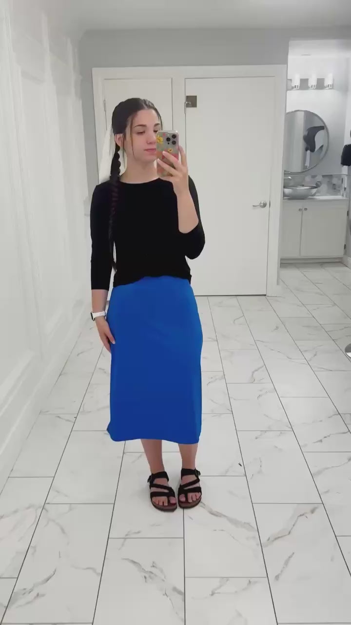 model wearing an All-Sport skirt blue modest skirt walking outdoors