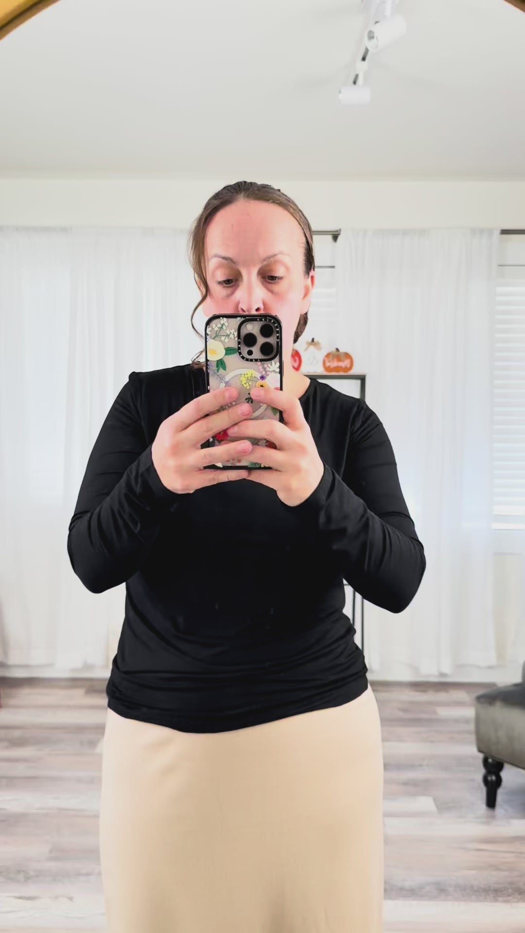 Woman showcasing fit and fabric of the Nuggles® long sleeve tee in a casual indoor setting.