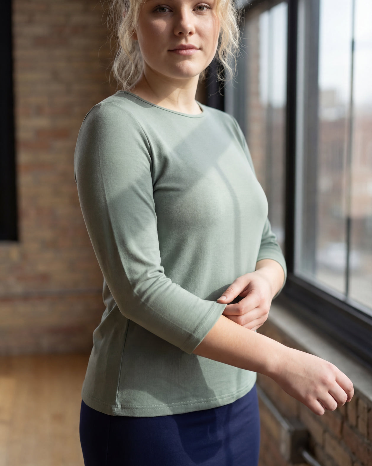 Model wearing the Nuggles® Essential 3/4 Tee in seafoam green